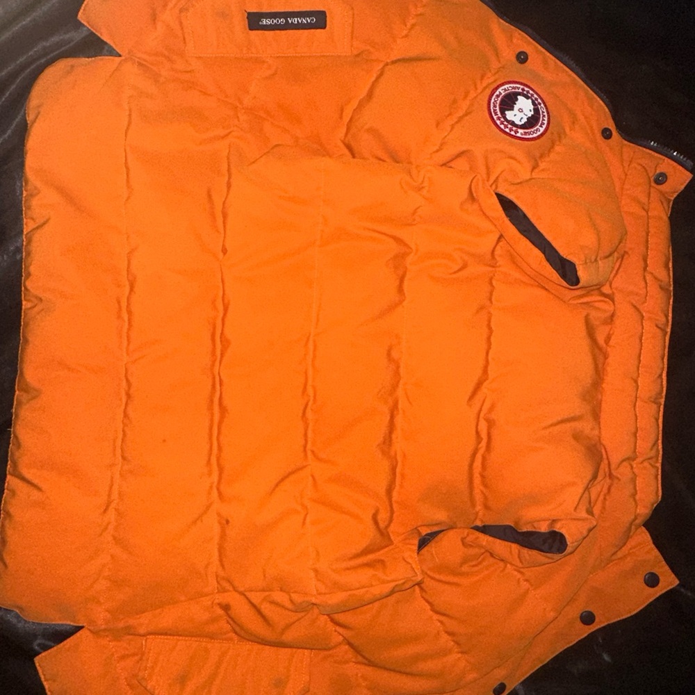 Bright orange slightly worn Canadian goose vest